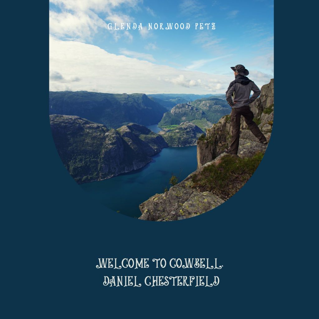 Cowboy standing on mountainside overlooking lake